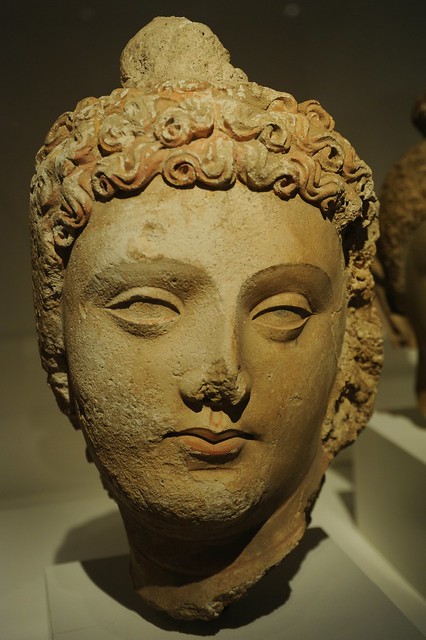 Face of Lord Buddha, head of curly hair, lips, almond shaped eyes, Pakistan or Afghanistan, Gandharan region, 4th/6th century, stucco with traces of pigment,  Art Institute of Chicago, Illinois, USA