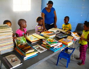Children looking at books that have arrived