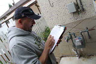 The energy auditor measures the exterior of th...