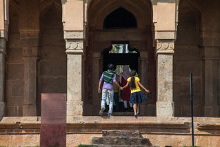 Young Indian couple on a date amongst the 15th Century temples and mausoleums in the Lodi Gardens - Delhi, India