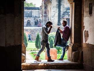 Two Indian guys hanging out laughing in the 15th Century Bara Gumbad ('Big Dome') - the Lodi Gardens - Delhi, India