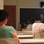 A professor listening to a students presentation