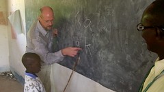 The Gambia: Teacher Helps Student Learn Letters