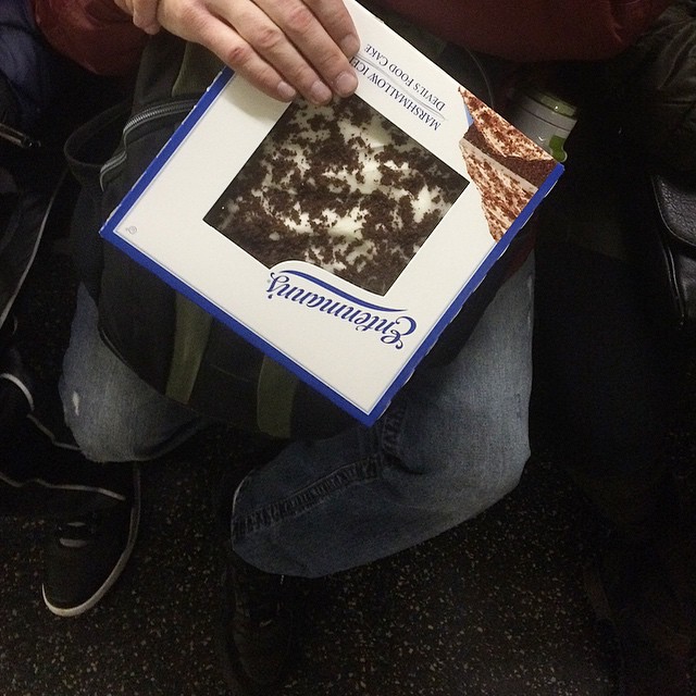 This guy has his blizzard emergency prep prioritized. Note he forwent a bag. I assume its in case crisis strikes mid way between Queens and Manhattan while on MTA. #blizzard #hunkerdown #eatcake