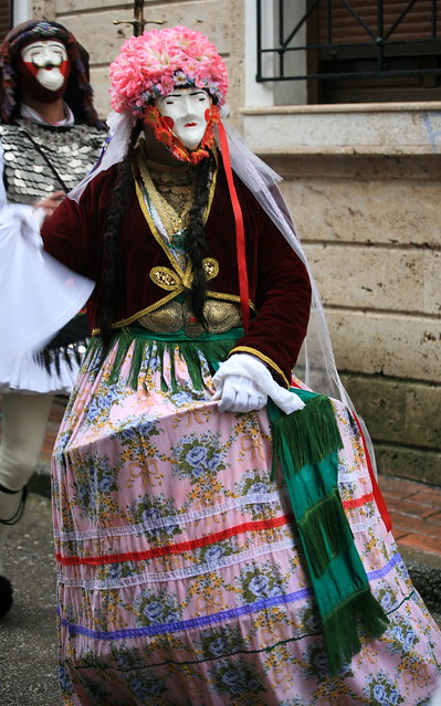 Naoussa.Genitsaroi and Boules.The Bulla are a man dressed woman with wide dress. At the head has flowers which start tulle and ribbons. Also wears a face like the Janissaries with the difference that has the female form