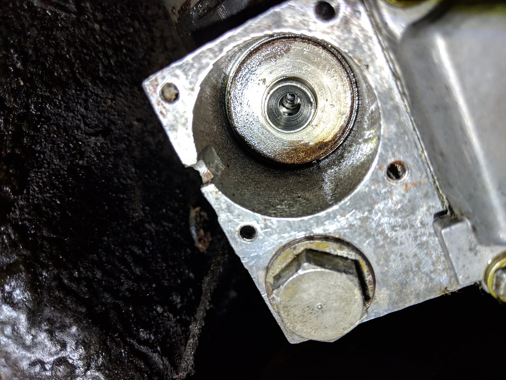 Cylindrical hole in the metal overdrive housing, with a thick metal disc at the bottom of the hole