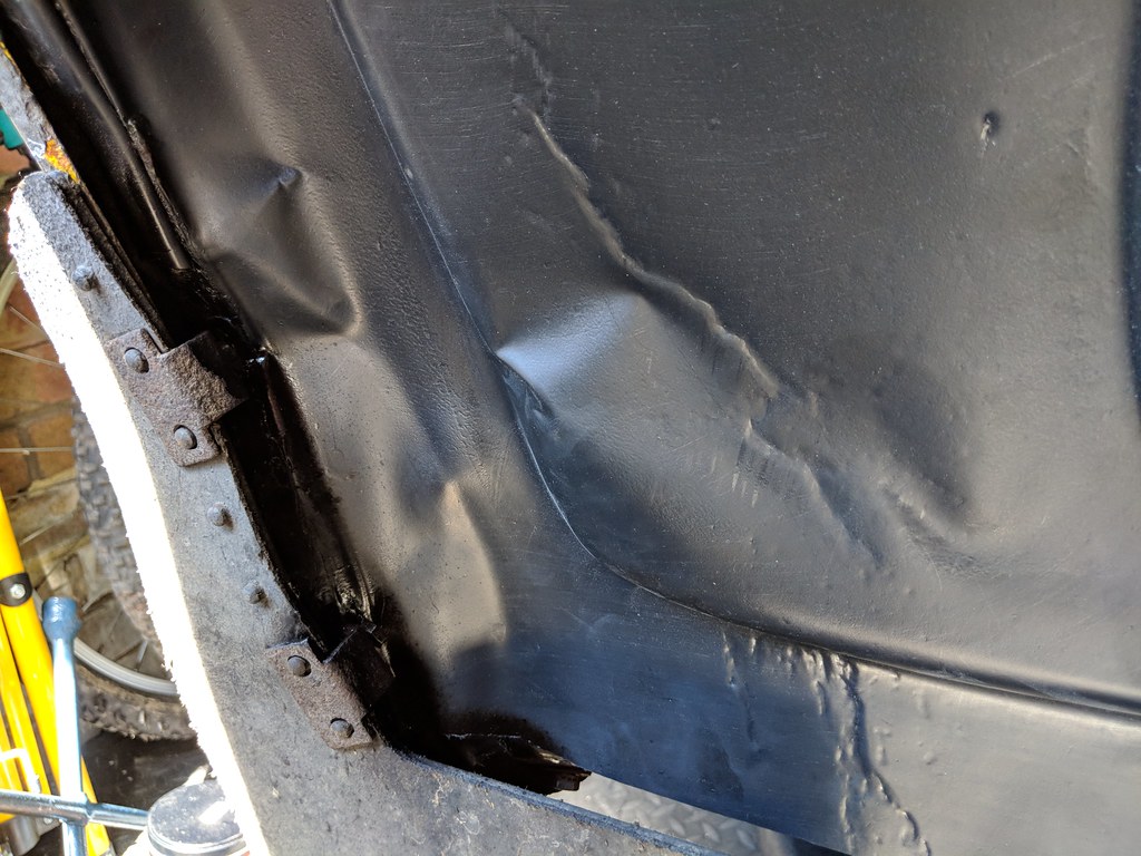 The rear edge of the liner fixed in place behind the mud-guard 