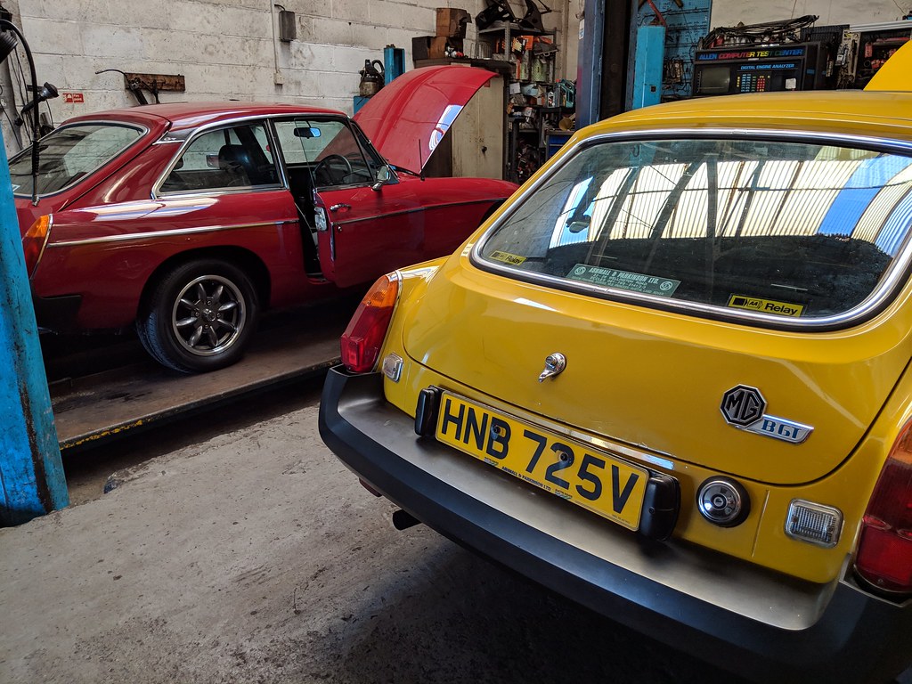 The B in Alf's workshop with a red B GT parked on the lift alongside