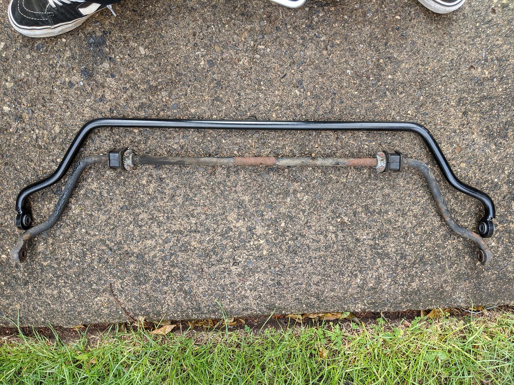 Two anti-roll bars side-by-side. The new one is thicker than the old one.