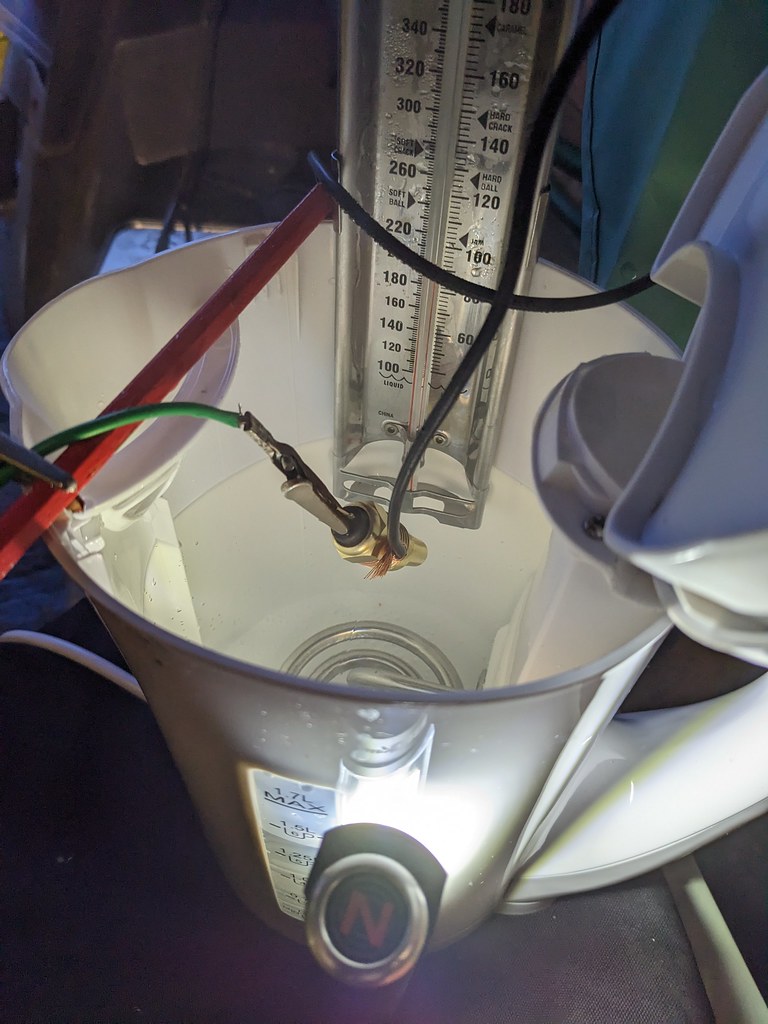 A kettle with the wired-up sender and thermometer submerged