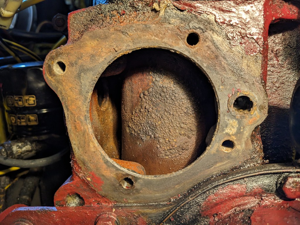 The inside of the engine block viewed through the hole for the water pump. The inside of the block is covered in scaling