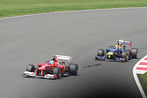 Fernando Alonso in his Ferrari leads Mark Webber in his Red Bull Racing at the 2012 British Grand Prix at Sivlerstone