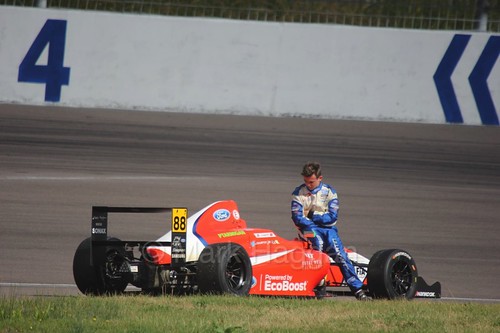 Jack Martin waits for his British F4 car to be recovered at Rockingham, August 2016