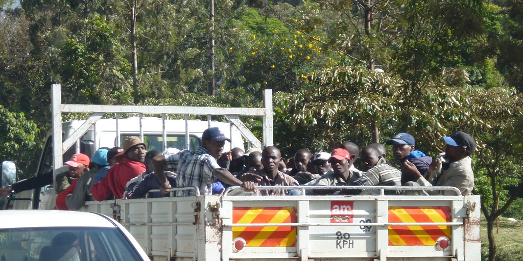 Image result for people on the back of a transit lorry in Kenya