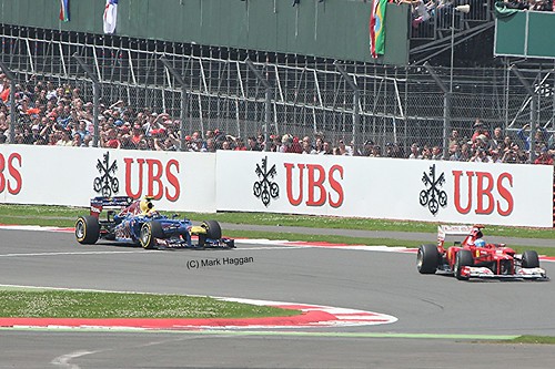 Fernando Alonso in his Ferrari leads Mark Webber in his Red Bull Racing at the 2012 British Grand Prix at Sivlerstone