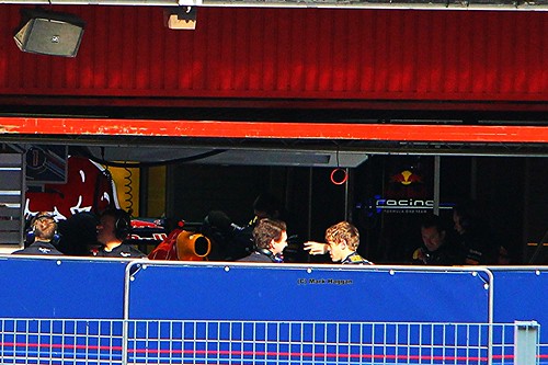 Sebastian Vettel and Christian Horner have a chat in the Red Bull Racing garage at Formula One Winter Testing in March 2012