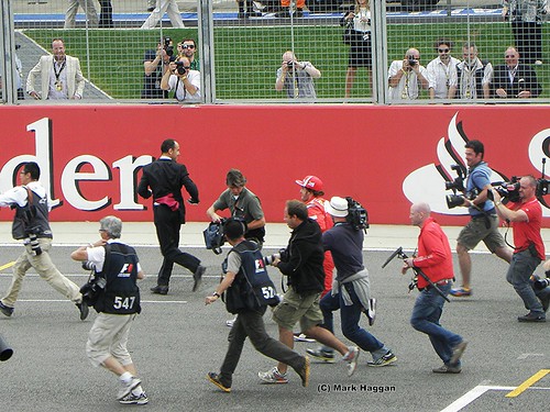 Fernando Alonso misses the drivers parade and runs to get on at the 2011 British Grand Prix