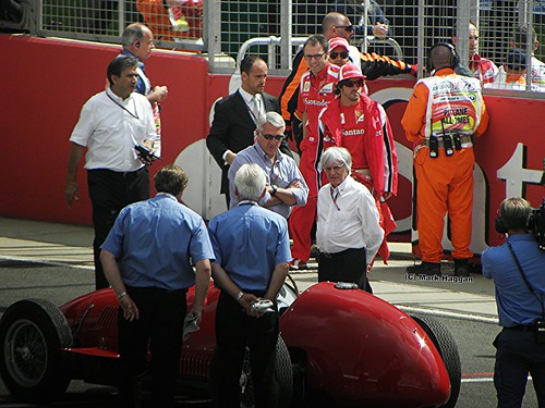 Bernie Ecclestone watches Fernando Alonso drive a historic Ferrari at the 2011 British Grand Prix