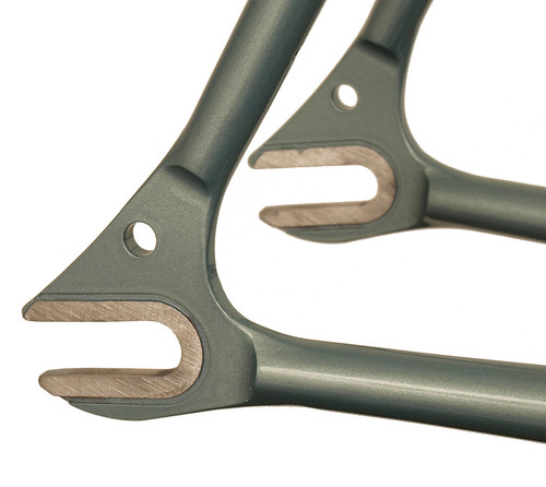 <p>Rear dropout detail on a Waterford 22-Series Artisan Road Fixed Gear in Sea Silver Poly.  It sports stainless steel track dropouts with bordered faces and a head tube extension.</p>