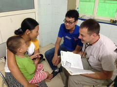 Dr. Jesse Hennum interviewing mom and child in Vietnam • <a style="font-size:0.8em;" href="http://www.flickr.com/photos/109076046@N08/29859890690/" target="_blank">View on Flickr</a>