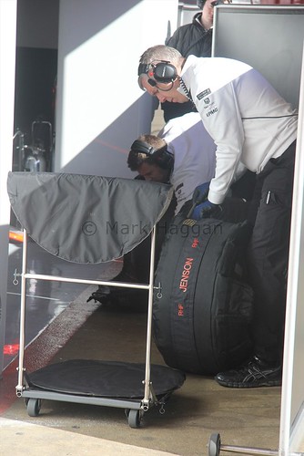 McLaren mechanics prepare Jenson Button's tyres during Formula One Winter Testing 2015