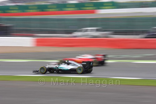 Nico Rosberg in his Mercedes passes a Ferrari in qualifying at the 2016 British Grand Prix