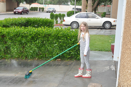 Nora decided to sweep the driveway since it was already wet from the rain. • <a style="font-size:0.8em;" href="http://www.flickr.com/photos/96277117@N00/15319722744/" target="_blank">View on Flickr</a>