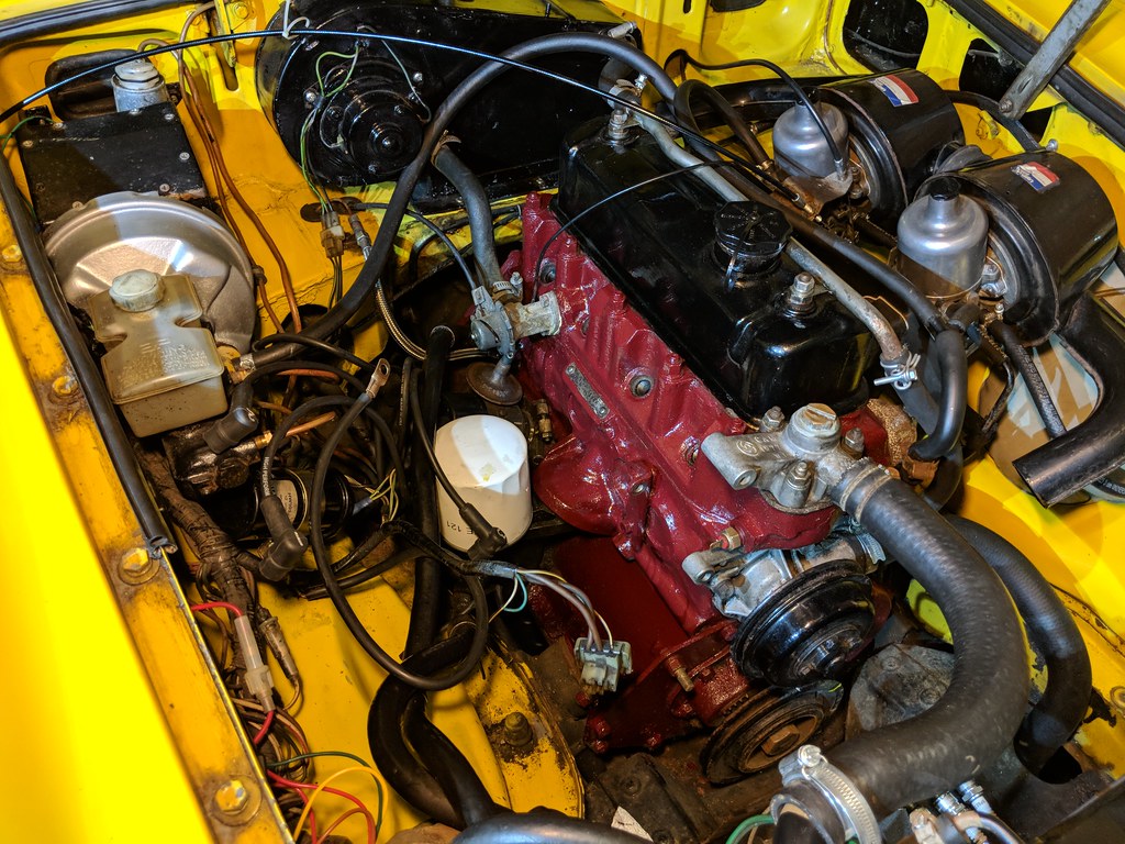 Engine bay with a freshly painted maroon red engine block
