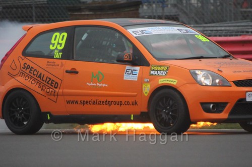 Alex Tait's car catches fire during the BRSCC Fiesta Junior Championship at Silverstone, April 2015